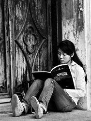 A girl reading in a design book at the St. Joseph church in Hanoi.